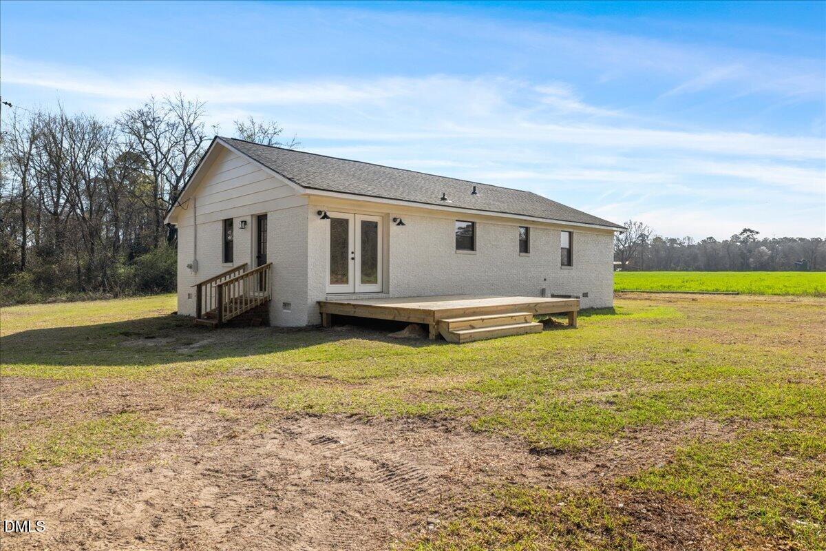 598 Bentonville Road Four Oaks, NC 27524 - Photo 33 of 40 a big white house with a large pool in front of it