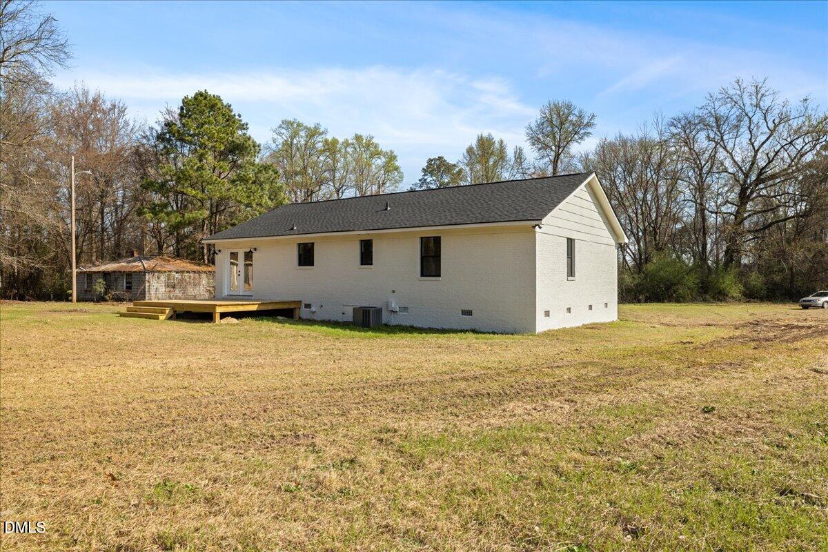 598 Bentonville Road Four Oaks, NC 27524 - Photo 35 of 40 a view of a house with backyard and tree
