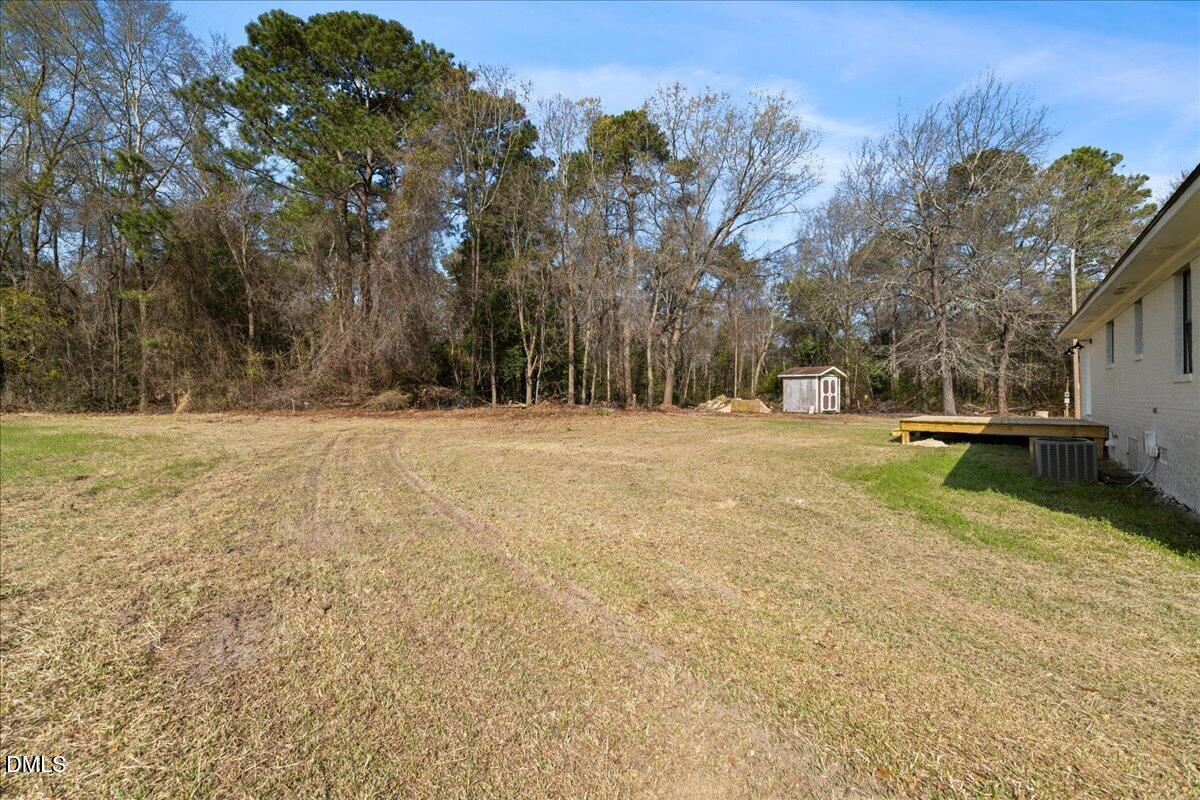 598 Bentonville Road Four Oaks, NC 27524 - Photo 36 of 40 a view of outdoor space with trees all around