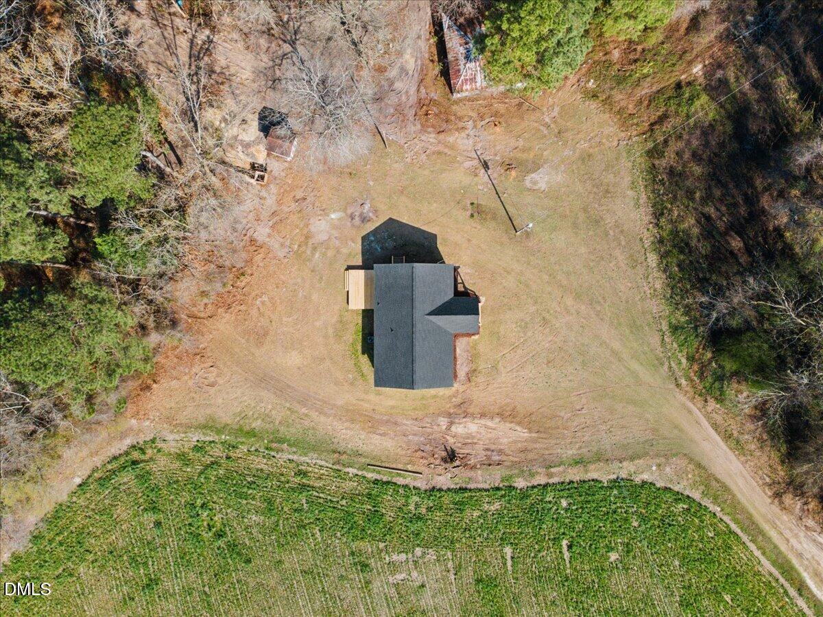 598 Bentonville Road Four Oaks, NC 27524 - Photo 40 of 40 a view of a garden with a brick wall