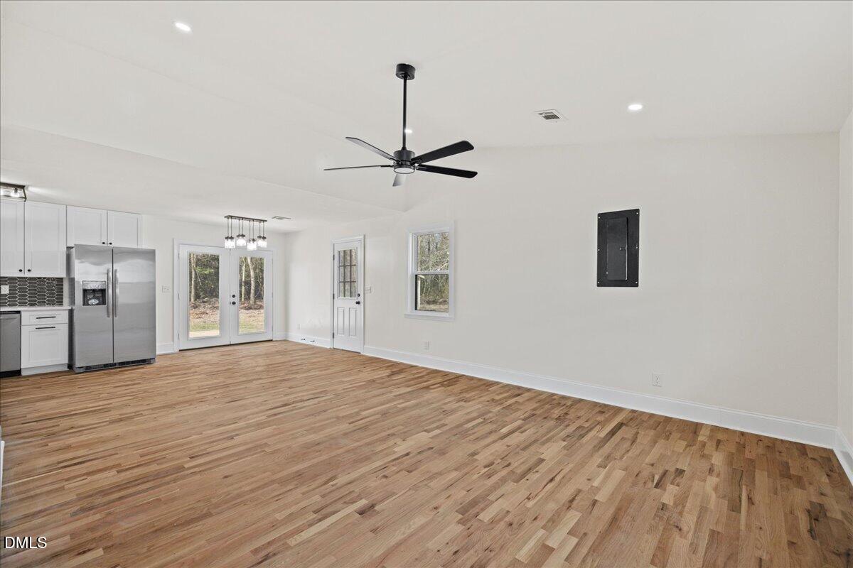 598 Bentonville Road Four Oaks, NC 27524 - Photo 9 of 40 a view of empty room with wooden floor and ceiling fan