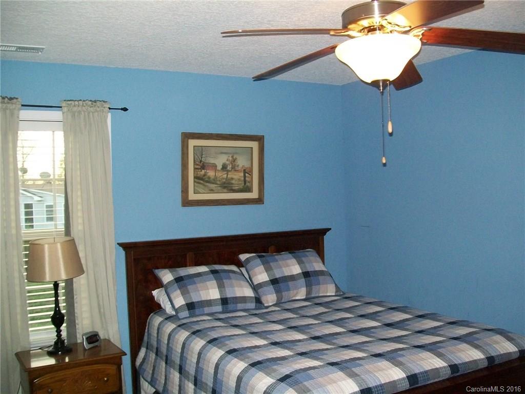 1434 State Rd S-46-323 York, SC 29745 - Photo 22 of 24 a bedroom with a bed and a chandelier