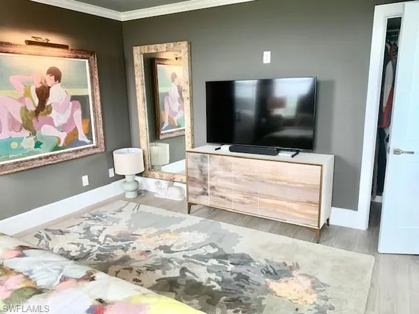 a living room with a flat screen tv and a rug