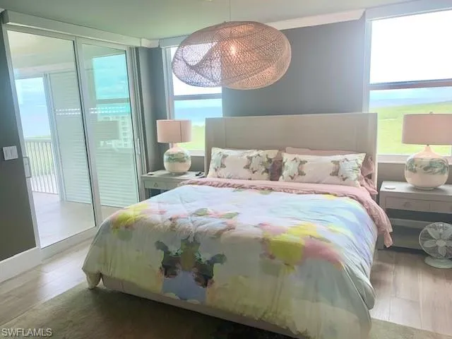 a bedroom with a bed mirror and window