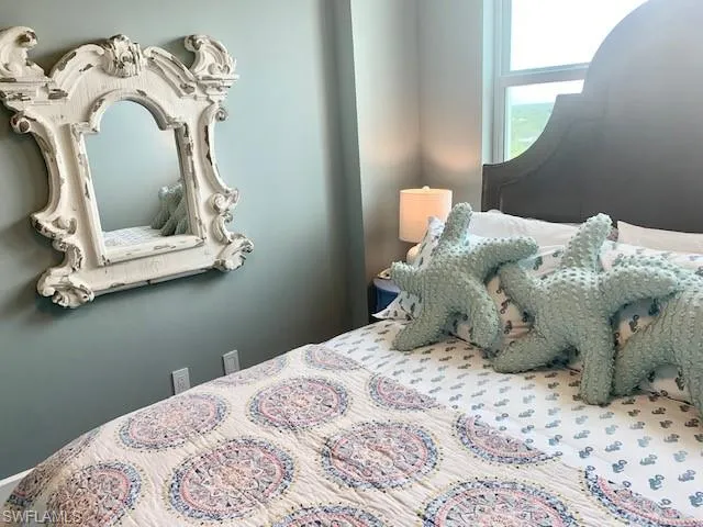 a bedroom with a bed and a mirror
