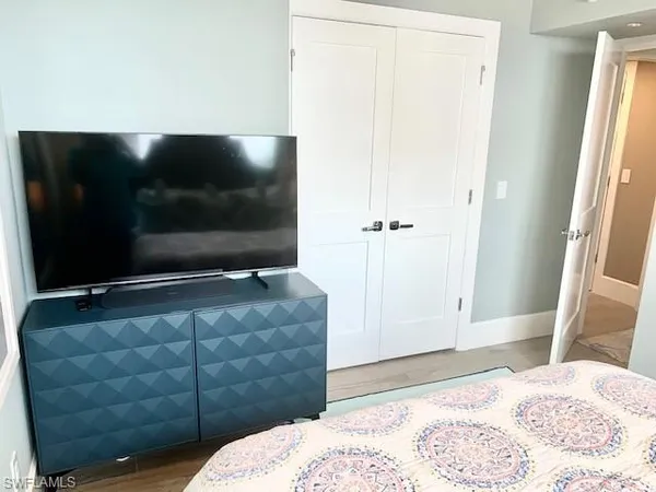 a bedroom with a bed and flat screen tv