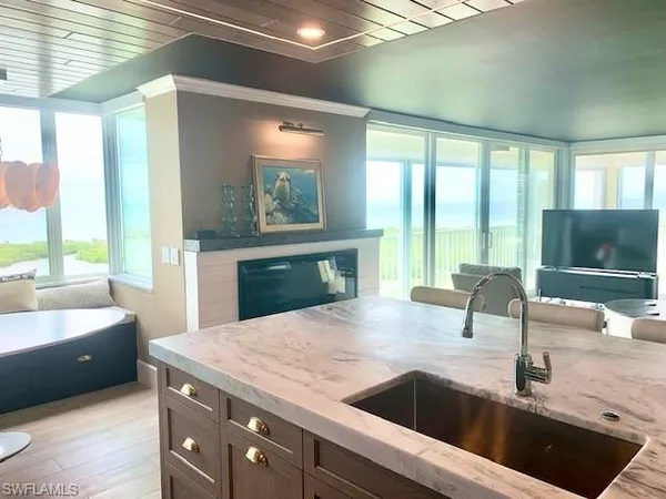 a kitchen with a sink and a large window with kitchen view