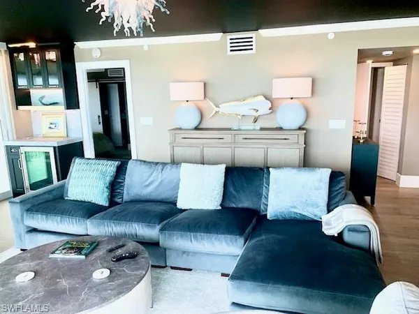 a living room with furniture and white walls