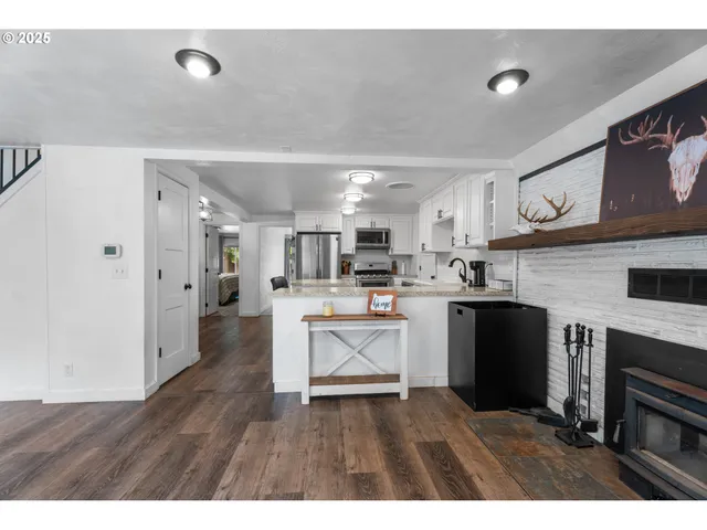 a kitchen with cabinets and wooden floor