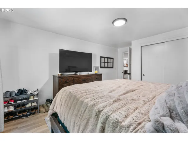 a bedroom with a bed and a flat screen tv