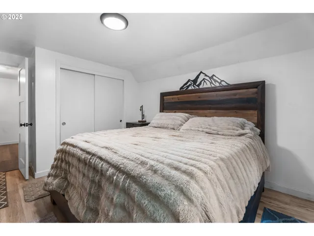 a bedroom with a bed and a potted plant