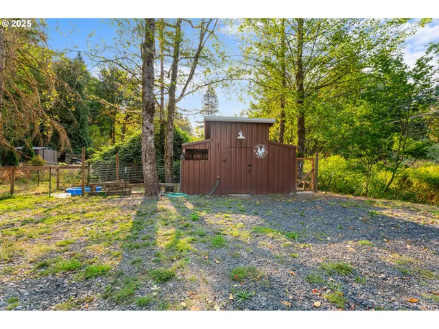 a backyard of a house with a yard and tree