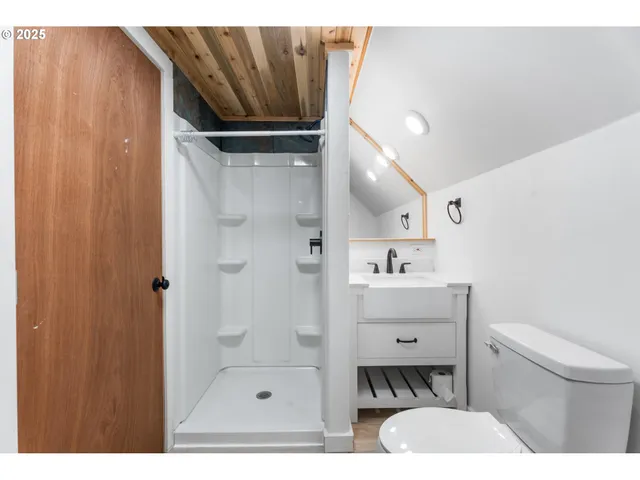 a bathroom with a sink toilet a shower and a mirror