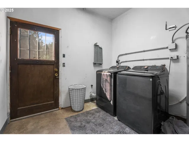 a backyard of a house with table and chairs