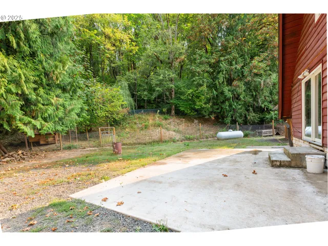 a backyard of a house with a yard and outdoor seating