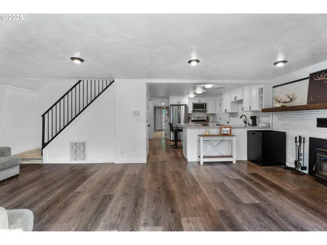 a view of kitchen with cabinets stainless steel appliances with wooden floor