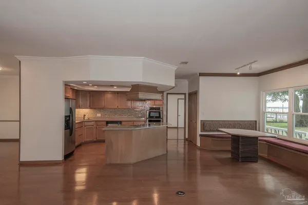 a view of a livingroom with furniture and hardwood floor