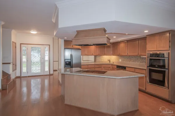 a kitchen with stainless steel appliances granite countertop a refrigerator and a sink