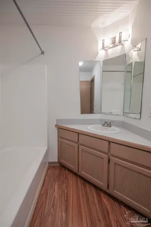 an empty room with closet and windows
