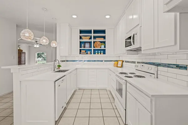 a kitchen with a sink stove and cabinets