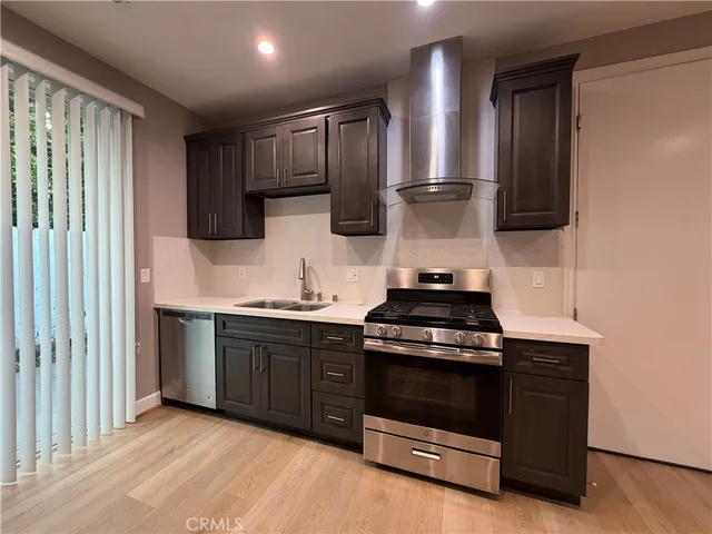 a kitchen with stainless steel appliances a stove and a refrigerator