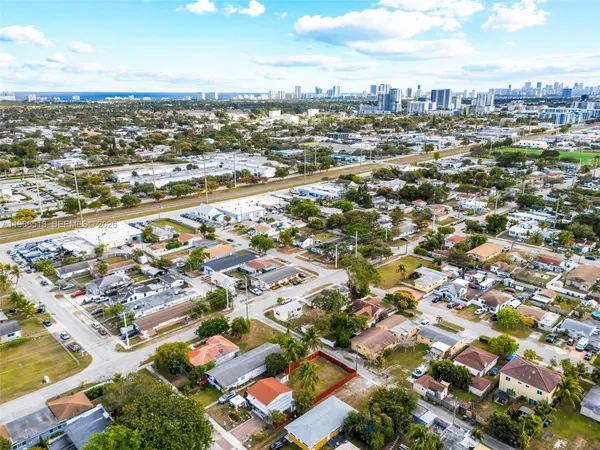 an aerial view of residential houses with city view