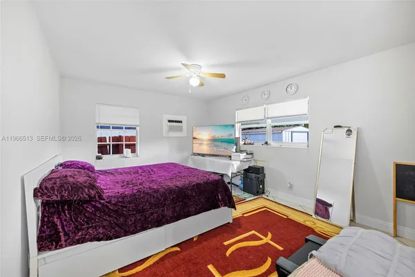 a bedroom with bed and a window