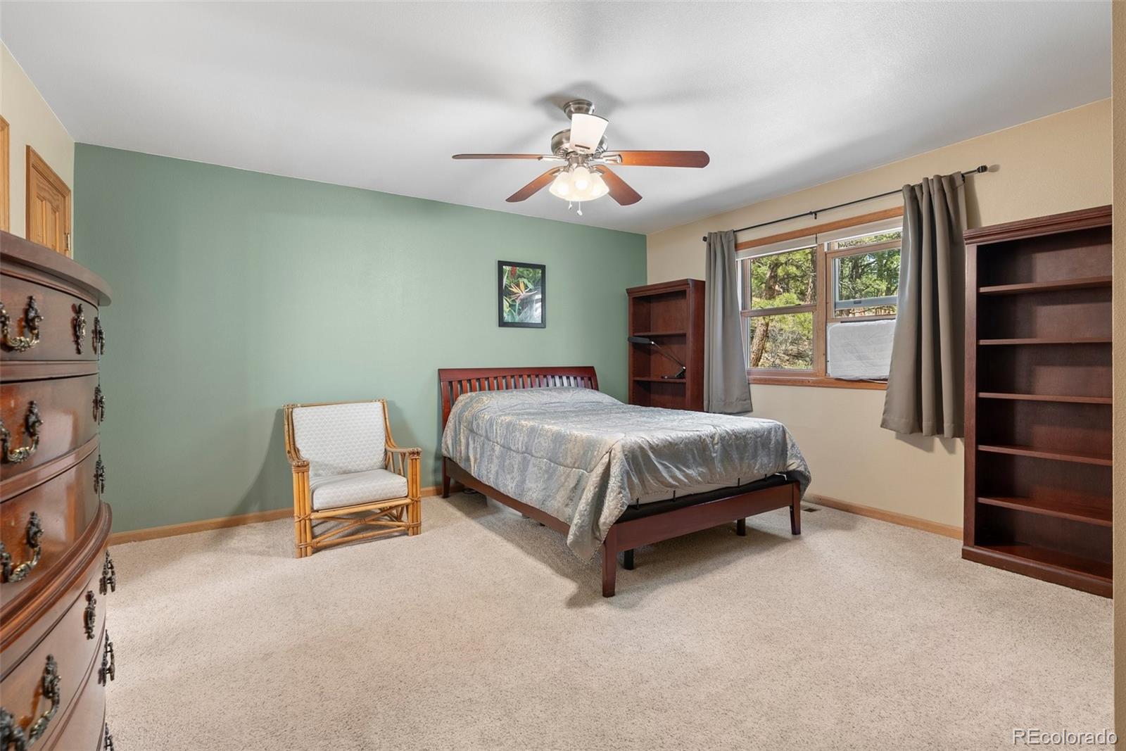 29 Cedar Lane Bailey, CO 80421 - Photo 12 of 46 a bedroom with a bed chair and dresser