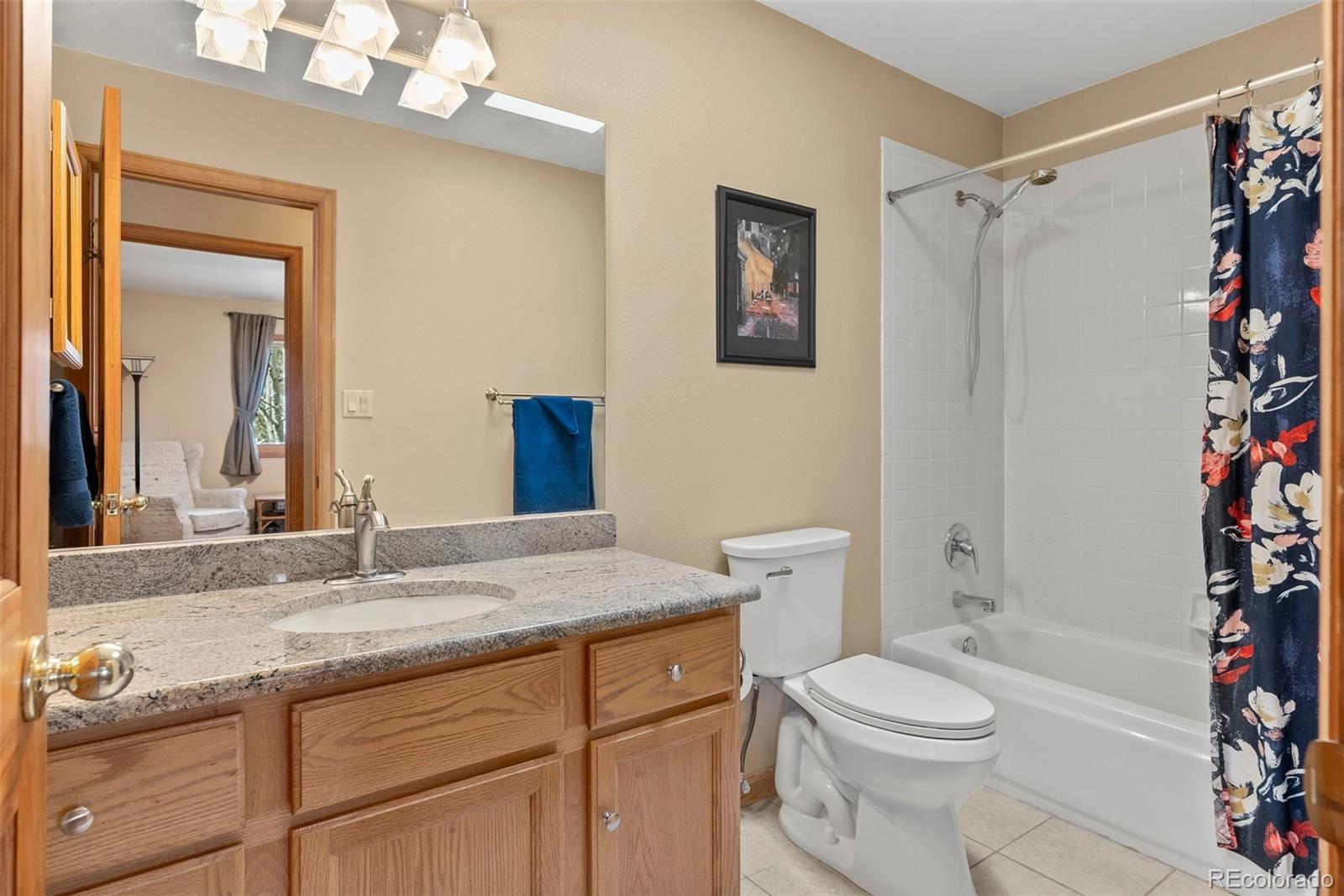 29 Cedar Lane Bailey, CO 80421 - Photo 18 of 46 a bathroom with a granite countertop sink toilet and shower