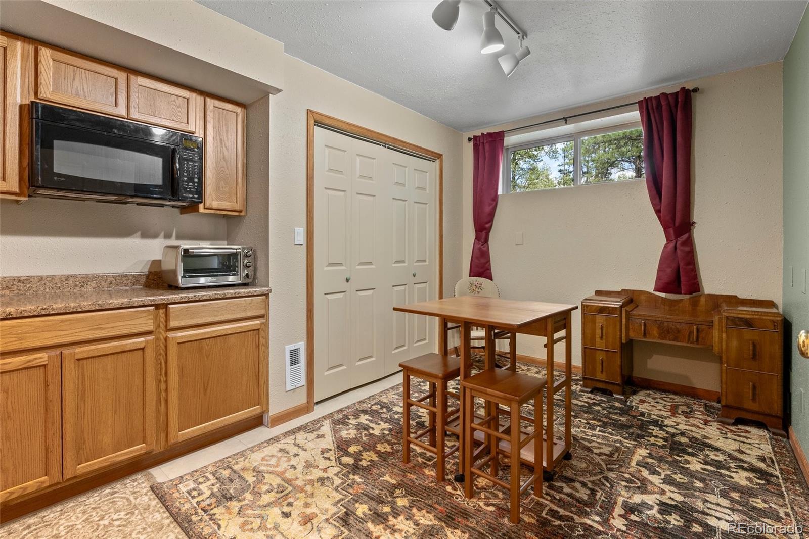 29 Cedar Lane Bailey, CO 80421 - Photo 21 of 46 a kitchen with a dining table and chairs