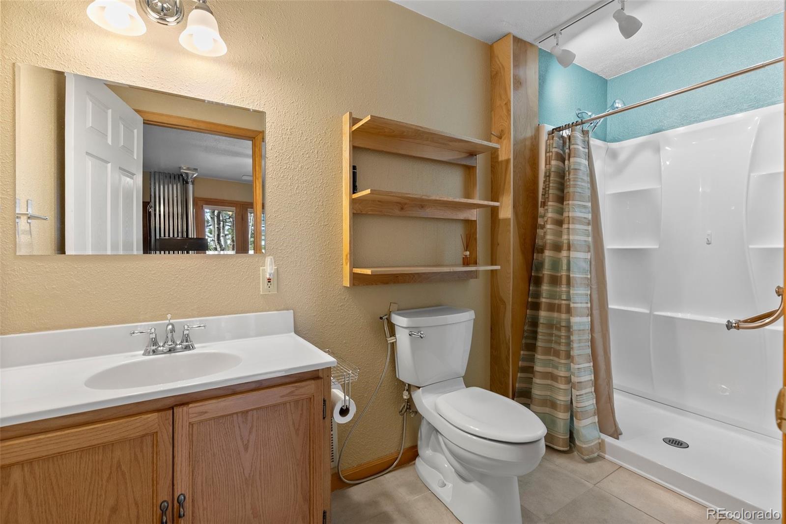 29 Cedar Lane Bailey, CO 80421 - Photo 23 of 46 a bathroom with a sink toilet and shower
