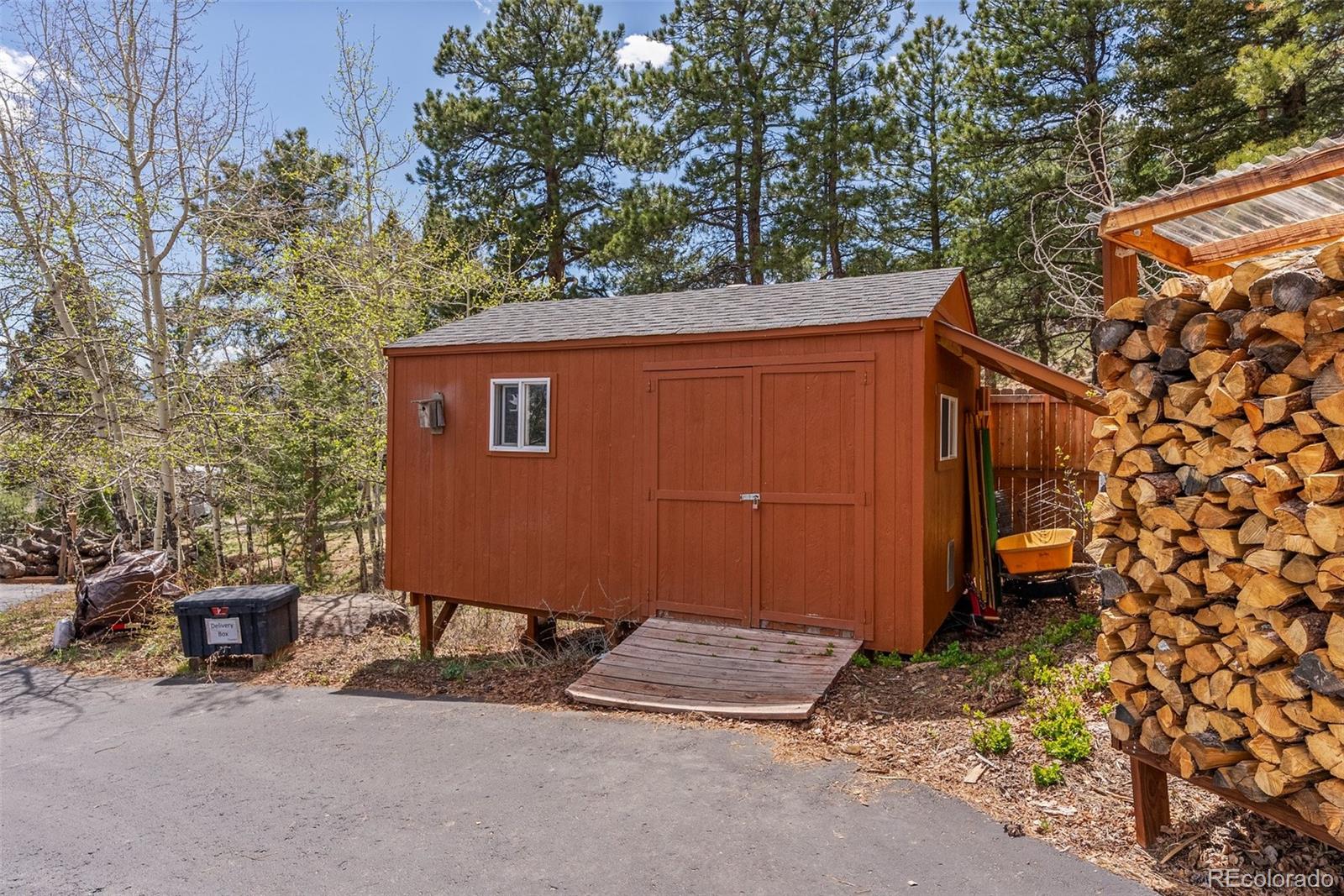 29 Cedar Lane Bailey, CO 80421 - Photo 34 of 46 a backyard of a house with table and chairs