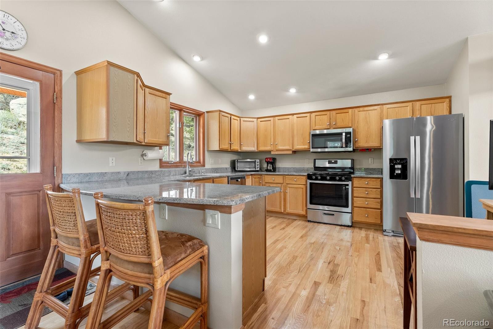 29 Cedar Lane Bailey, CO 80421 - Photo 7 of 46 a kitchen with granite countertop wooden cabinets and stainless steel appliances