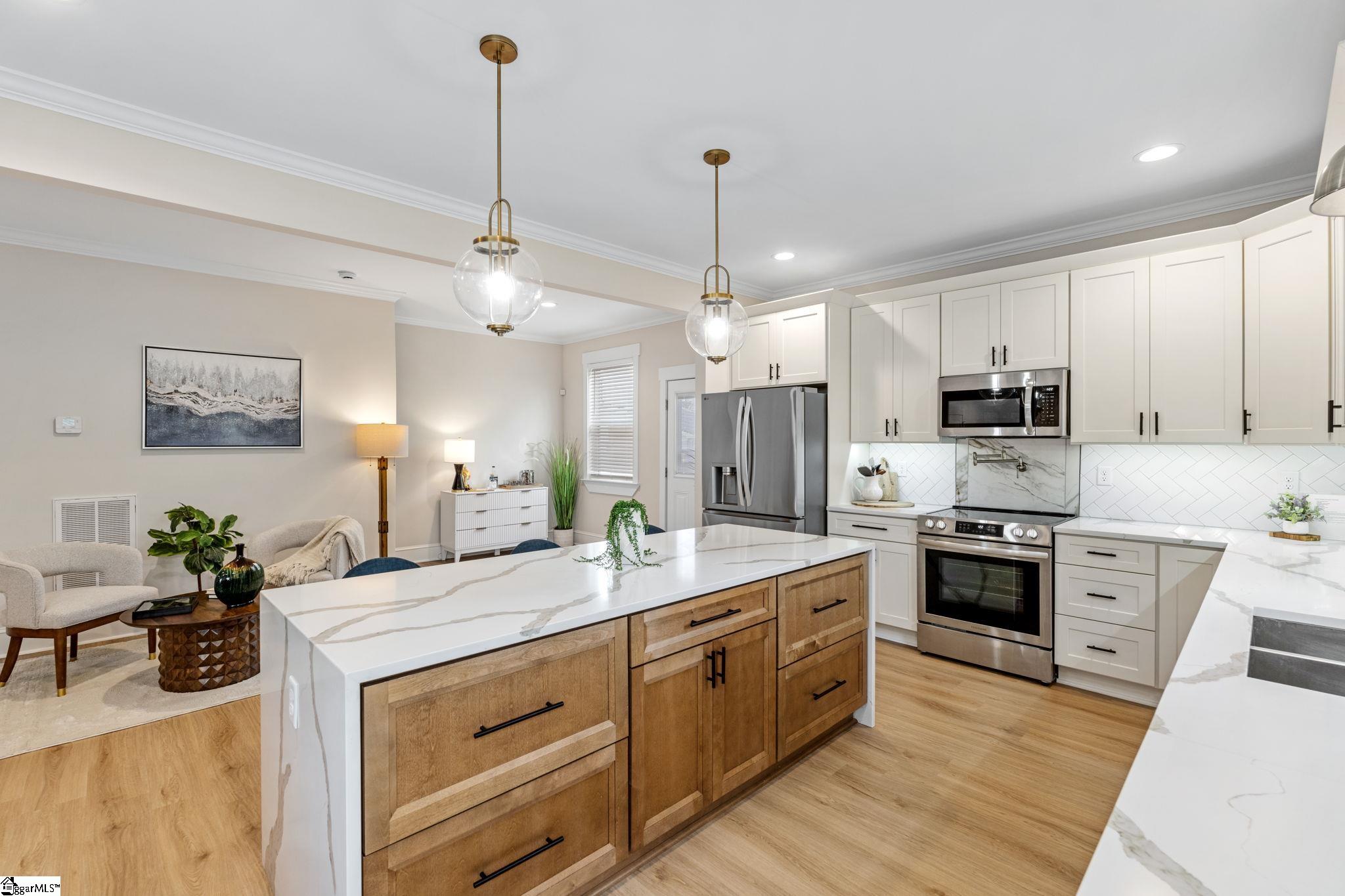 108 Averill Street Greenville, SC 29601 - Photo 14 of 43 Accent cabinet finish highlights the large island.