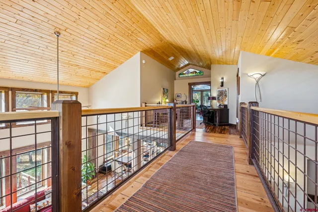 a view of a porch with wooden floor and iron stairs