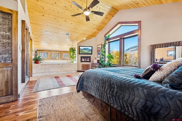 a bedroom with a bed and a large window with outer view