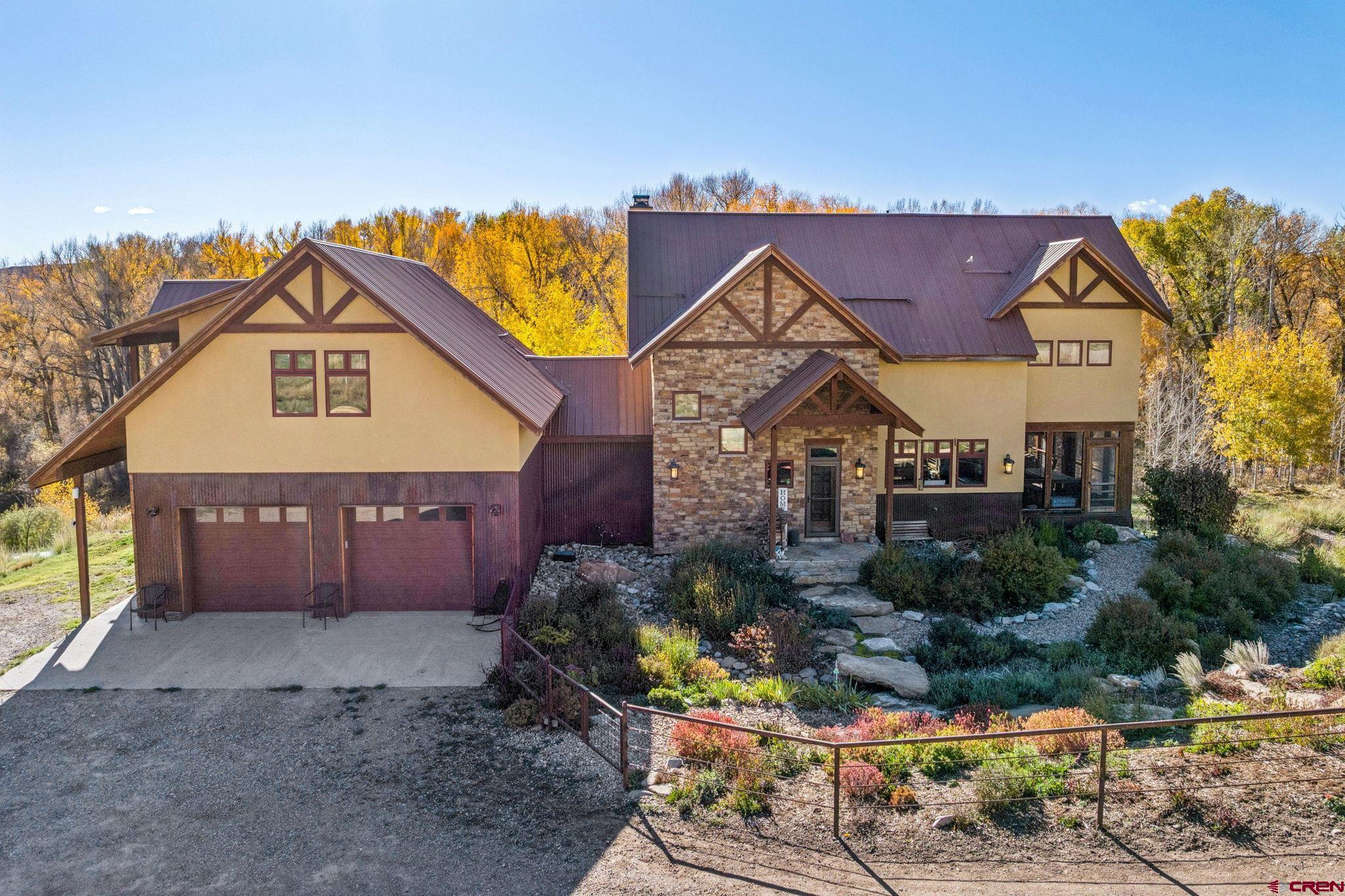 125 Quaking Aspen Road Durango, CO 81301 - Photo 2 of 45 a view of a house with a small yard and plants