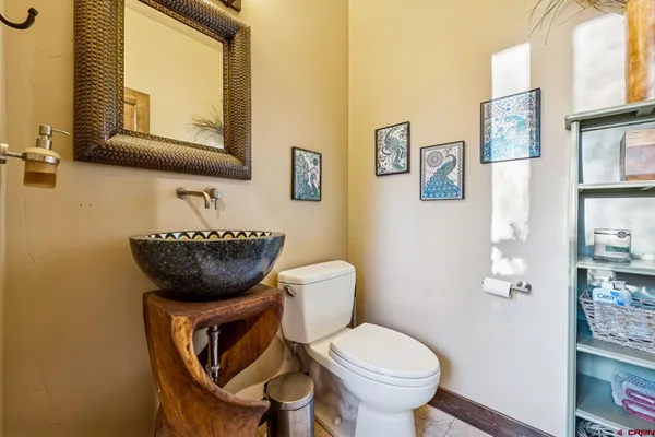 a bathroom with a toilet a sink and mirror