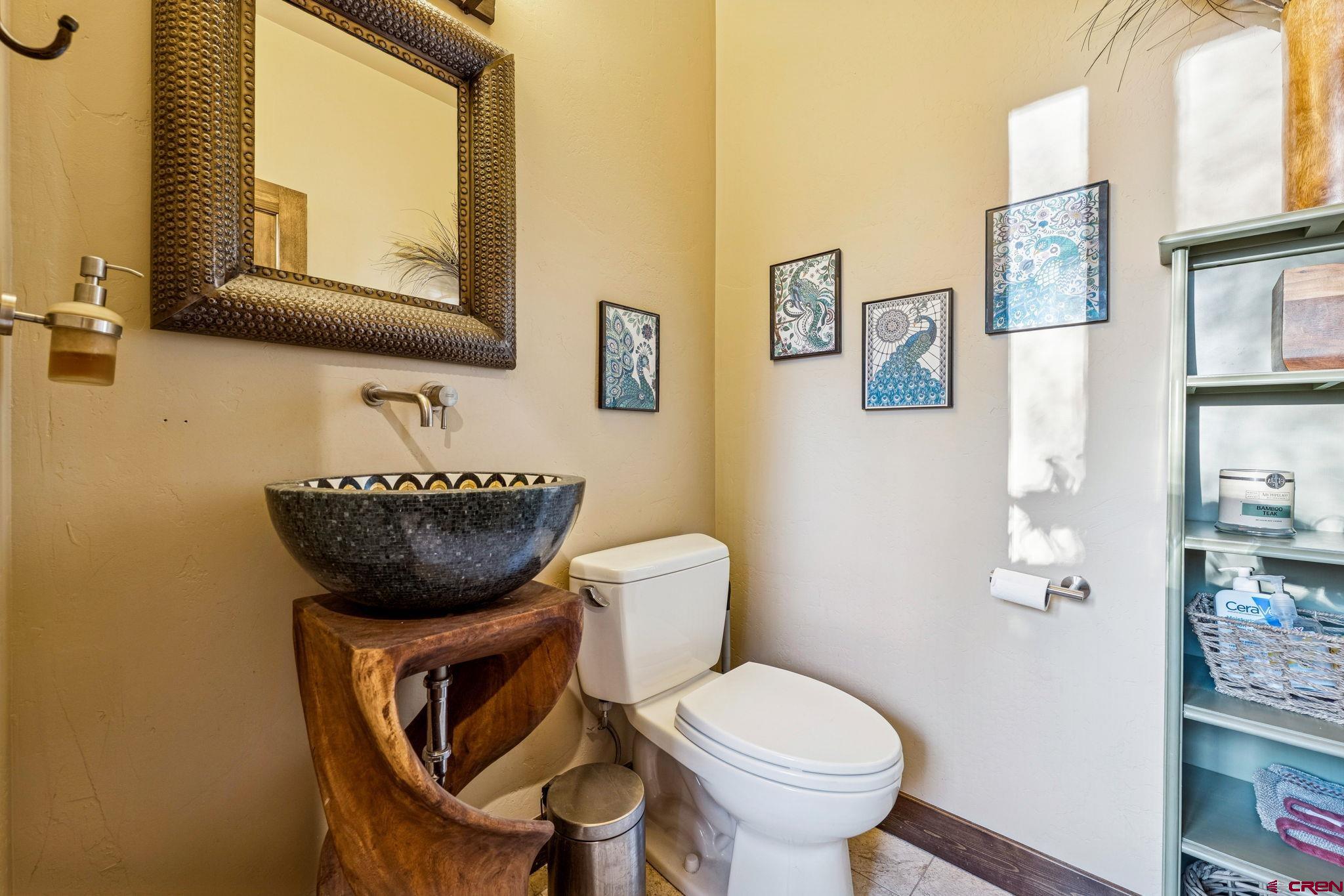 125 Quaking Aspen Road Durango, CO 81301 - Photo 25 of 45 a bathroom with a toilet a sink and mirror
