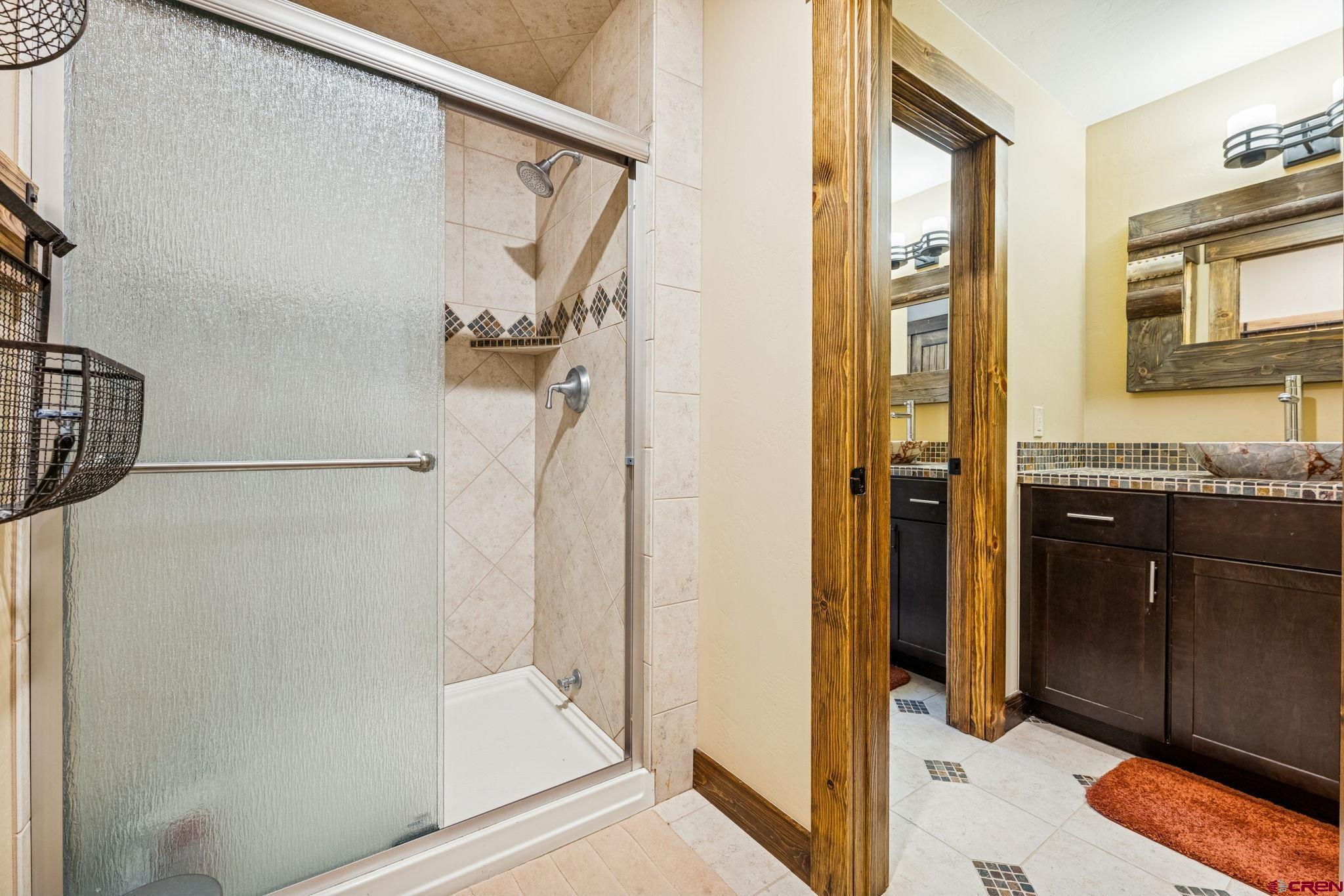 125 Quaking Aspen Road Durango, CO 81301 - Photo 29 of 45 a bathroom with a granite countertop shower mirror and a sink