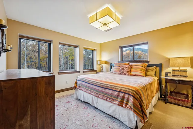 a bed sitting in a bedroom next to a window