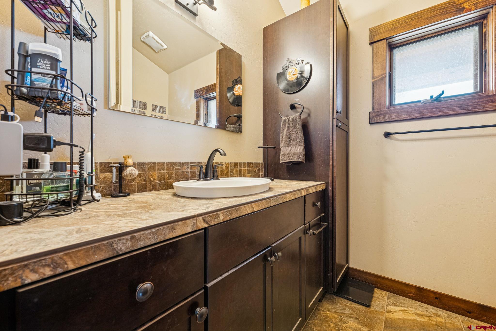 125 Quaking Aspen Road Durango, CO 81301 - Photo 38 of 45 a bathroom with a sink a vanity and a mirror
