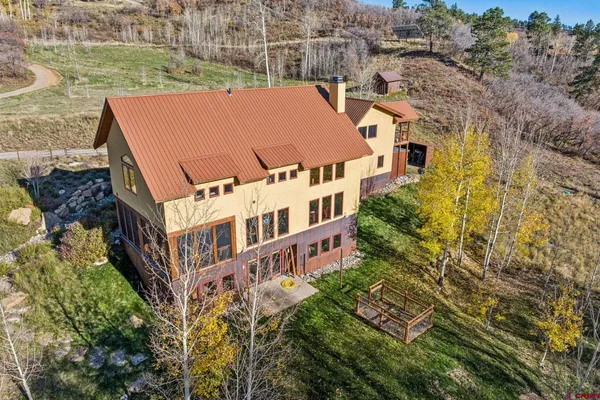 an aerial view of a house with a yard