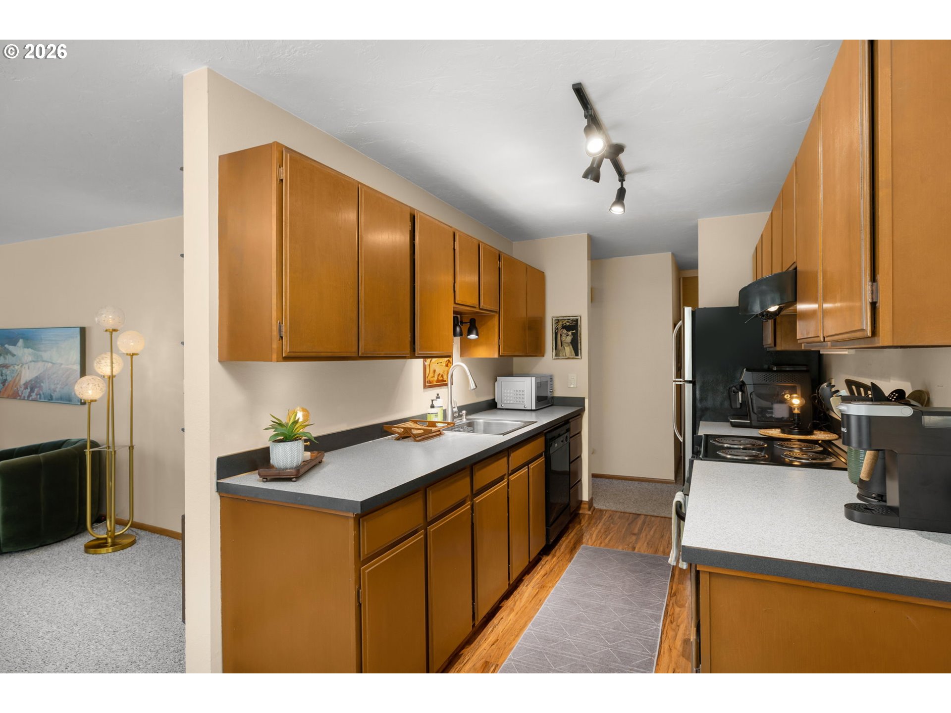 2393 Southwest Park Place, Unit 302 Portland, OR 97205 - Photo 12 of 35 a kitchen with a sink stove and refrigerator