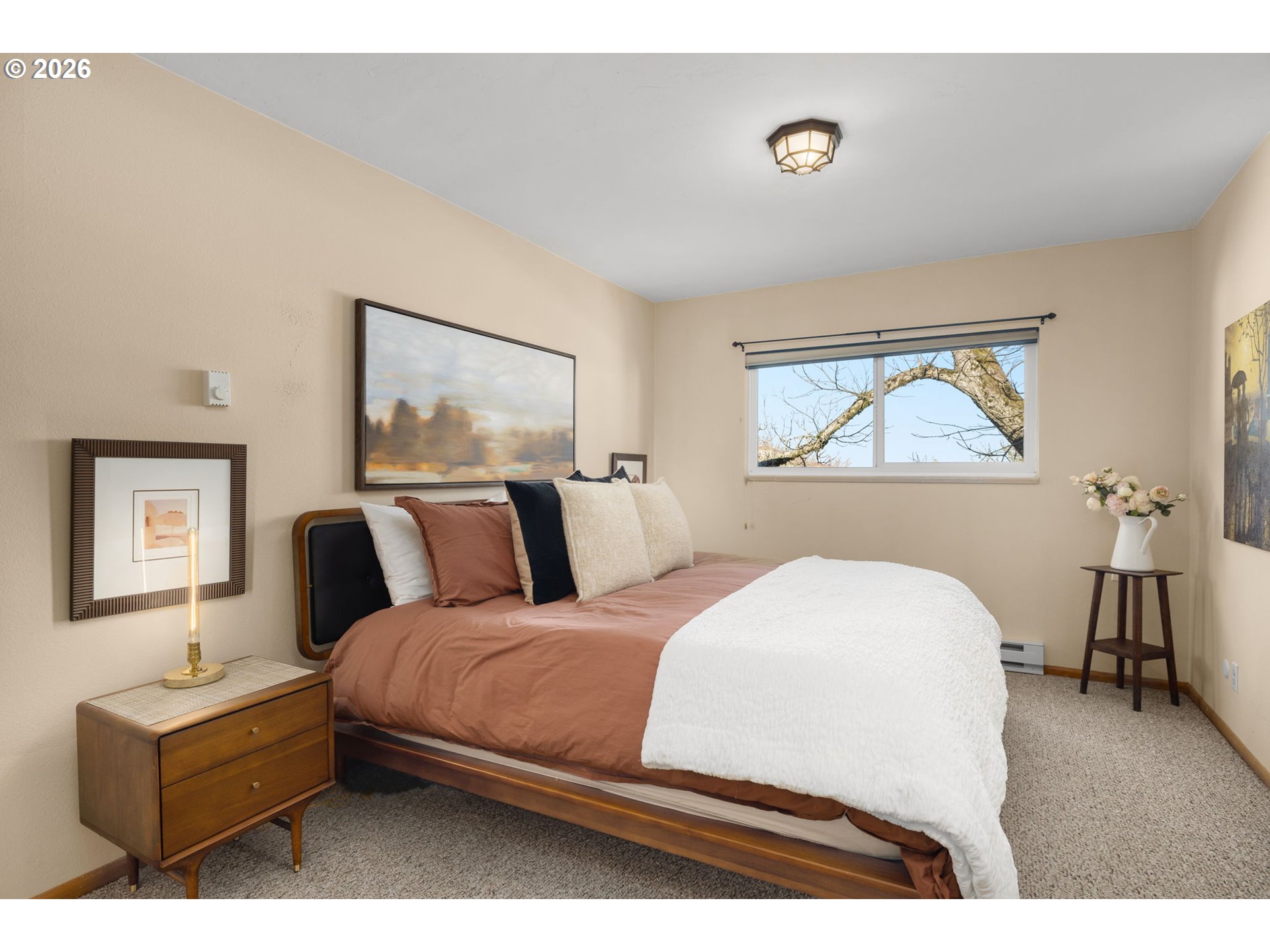 2393 Southwest Park Place, Unit 302 Portland, OR 97205 - Photo 21 of 35 a bedroom with a bed and a chandelier