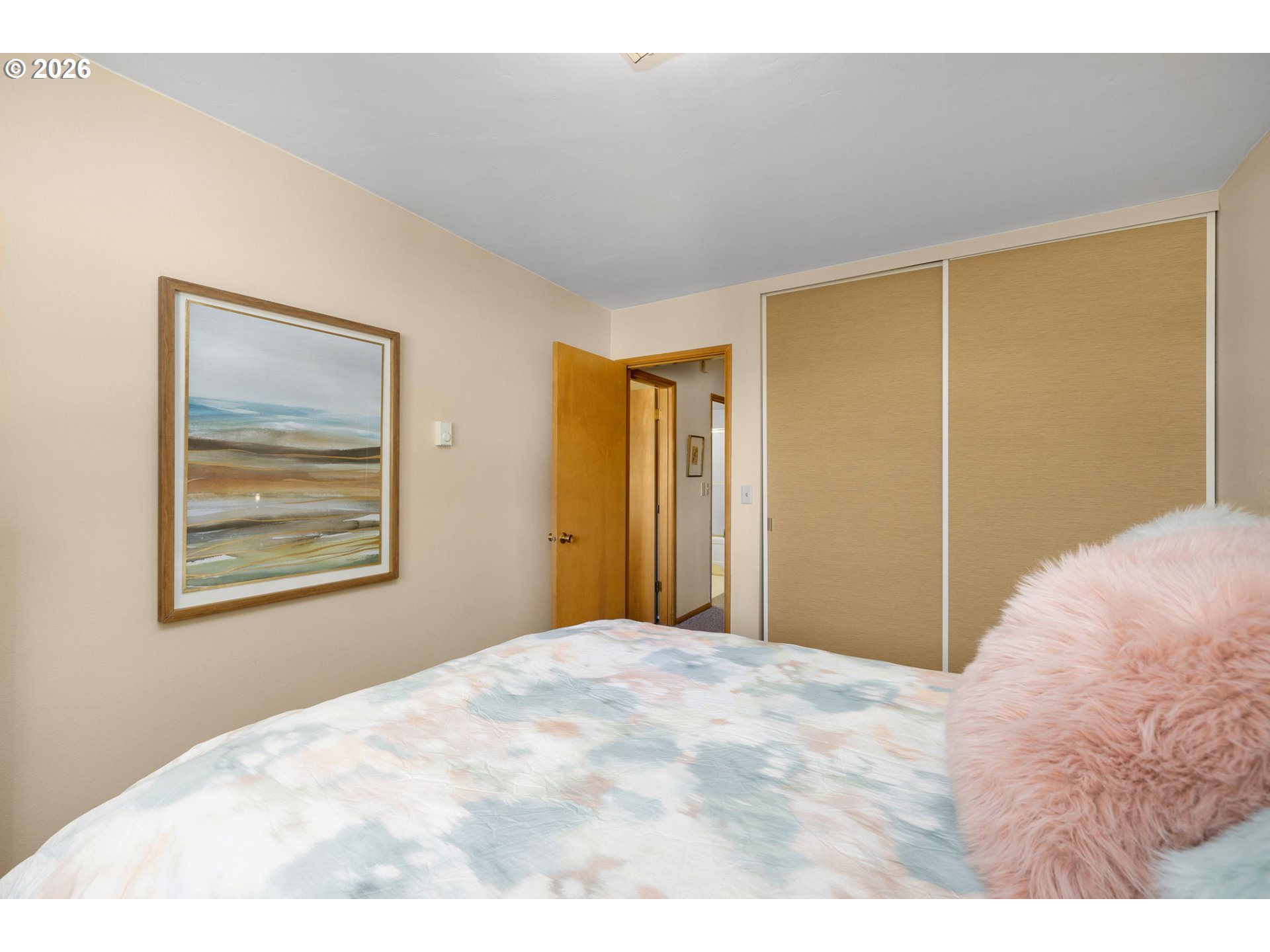 2393 Southwest Park Place, Unit 302 Portland, OR 97205 - Photo 26 of 35 a bedroom with a bed and a painting on the wall