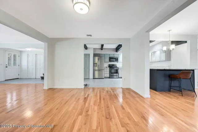 a large kitchen with stainless steel appliances kitchen island granite countertop a stove and a sink