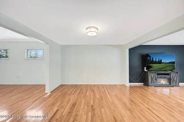 a open kitchen with stainless steel appliances granite countertop a stove and a wooden floors