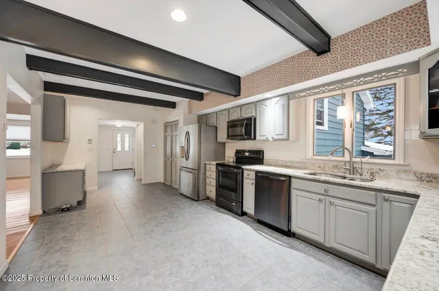 a bathroom with a sink a mirror and a shower