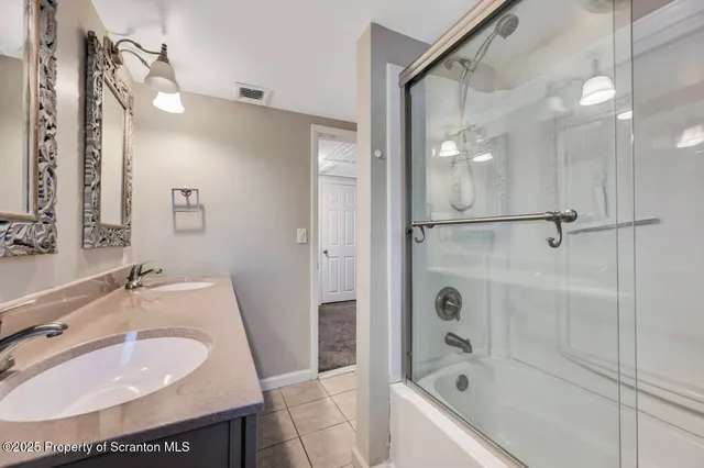 a view of an empty room with window and closet area